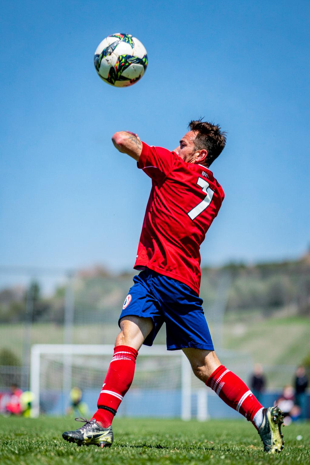 Youth soccer defender sliding to win the ball